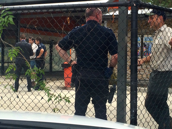 On the hunt: Warrandyte police and local rangers meet at the car wash to discuss the grisly find